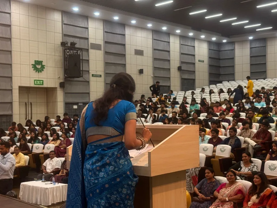 Saijal at the podium, hosting the Freshers’ Event in a full auditorium