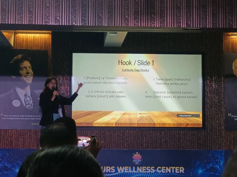 Saijal presenting a slide of curiosity-gap hook formulas to the room